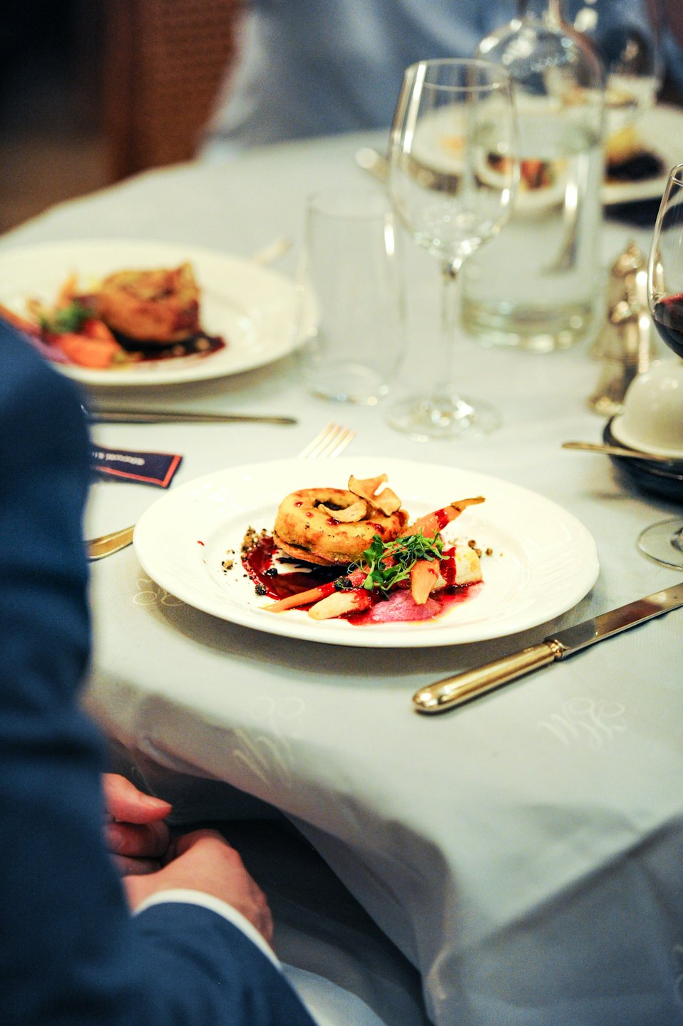 Gourmet fried dish with vegetables served on a white plate.